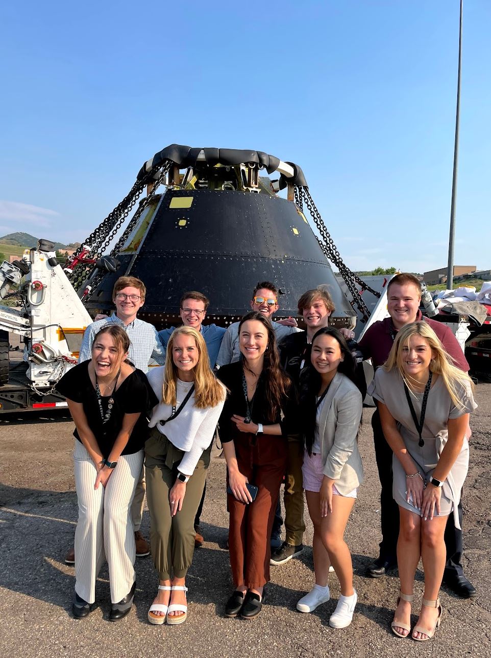 Two monitors side by side with a Mac laptop on the left and an Alienware desktop on the right